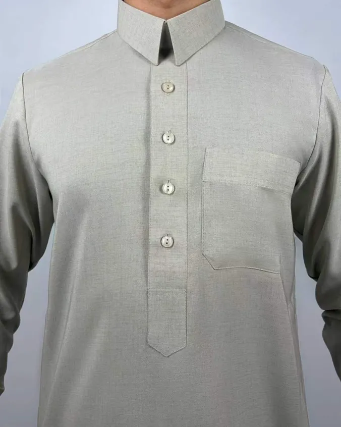 Close view of a pale sage collared thobe with a four-button placket and a square chest pocket