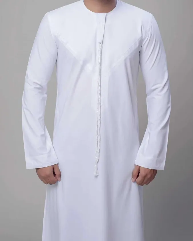 Man wearing a plain white full-length Emirati kandura with long sleeves, a round collar and a corded front tassel